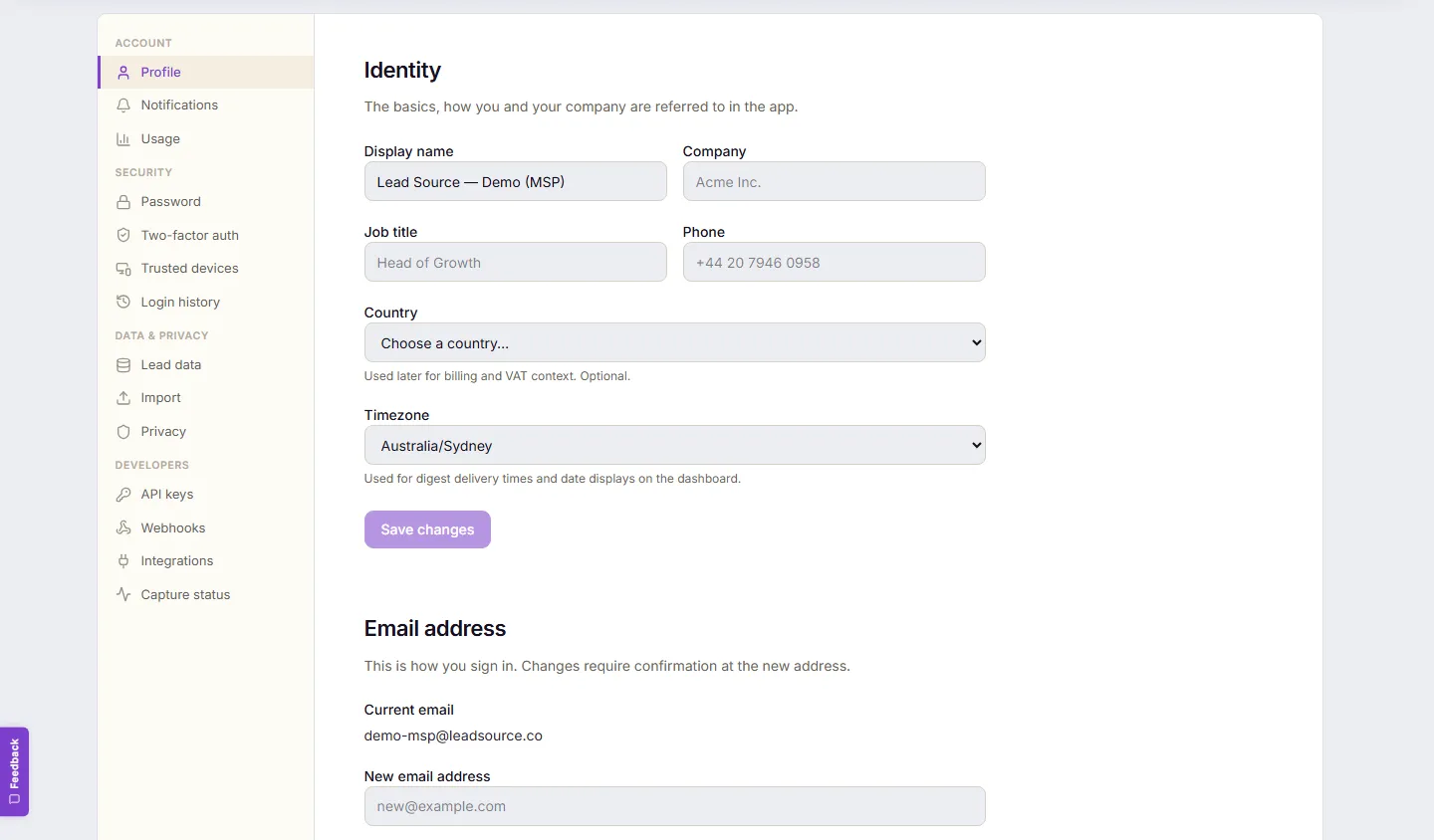 Settings → Profile. An Identity section with display name, company, job title and timezone fields, and below it an Email address section showing the current sign-in email and a field for a new email address.